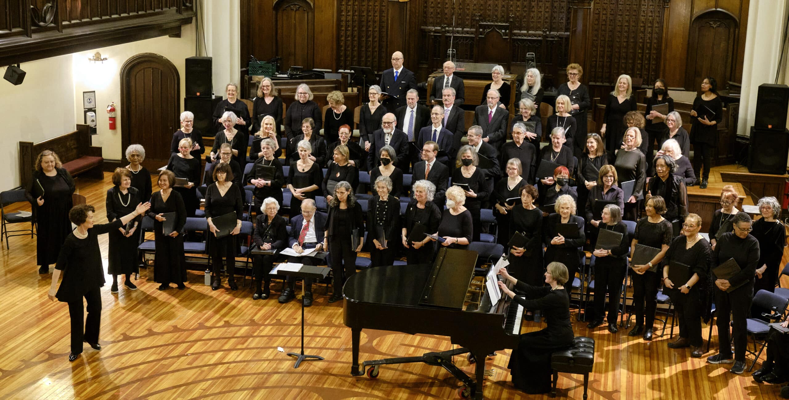 Encore Chorale of New York City East and West singers take a bow after their performance.